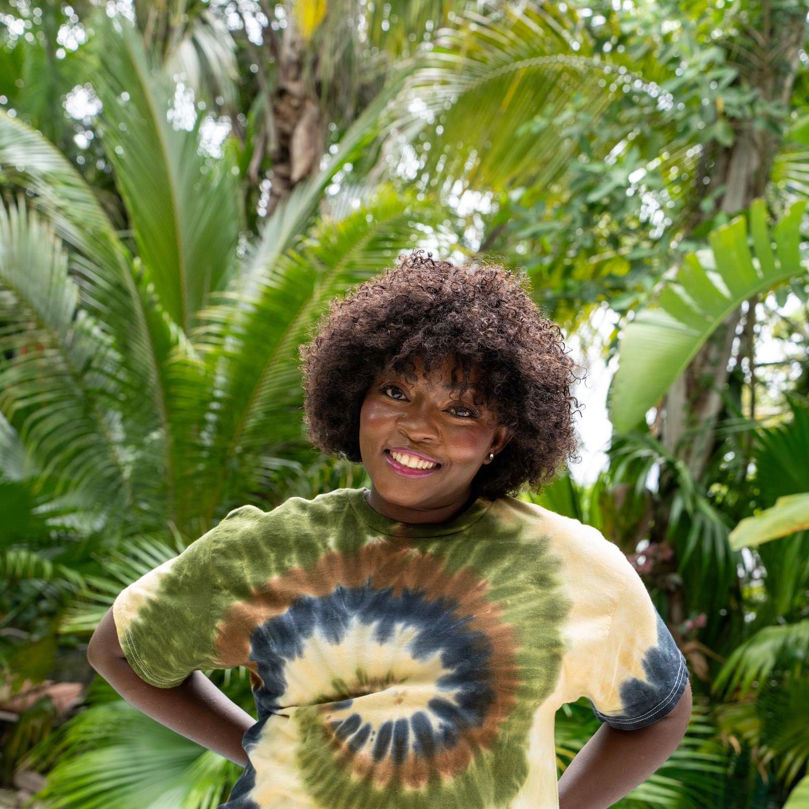 Tie-dye tees - woman smiling in a camo swirl hand-dyed tee by the pool